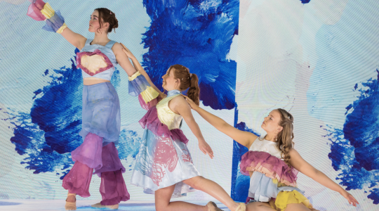 3 students on smart stage wearing fashion garments by Eleanor Hoad