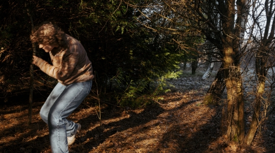 blurry photo of man in the woods