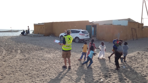 Toby Meredith with a group of children chasing a drone