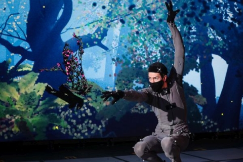 student performing in a play with the stage setup to look like a forest