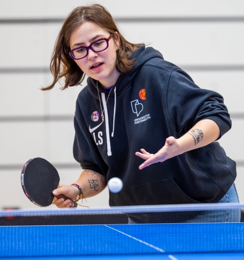 Lucille the blog writer playing table tennis
