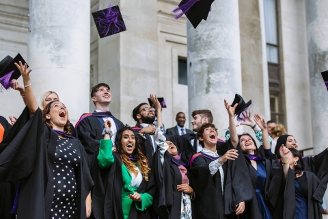 Graduates throwing hats 