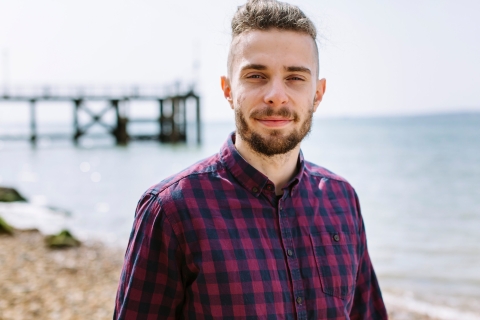 Profile shot of Jakub on the seafront