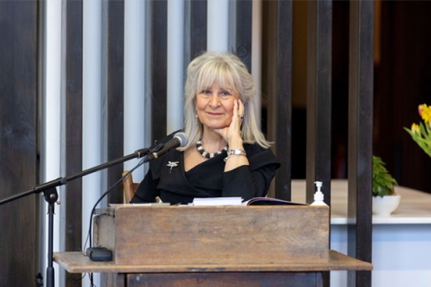 Baroness Helena Kennedy smiling to camera behind speech podium
