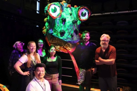 Dr Matt Smith with researchers with the 'Enzyme Eating Monster' puppet