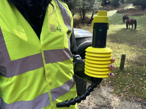 Someone holding a prototype of a new sensor to detect greenhouse gases in water 