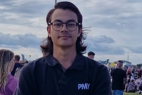 James Edge looking to camera wearing black PMY Group polo t-shirt at Victorious Festival