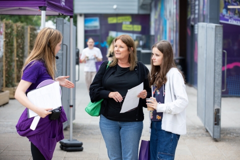 Student ambassador helping family with questions  - Open Day 2023