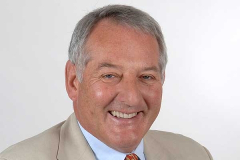 Sir Jonathan Band smiling to camera in headshot