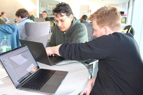 Two students looking at laptops