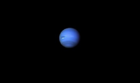 Image shows a blue planet looking like Earth against the dark backdrop of outer space, that is to say, the universe