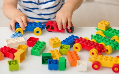 Child playing with Lego