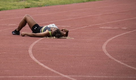 An athlete lying down on a track
