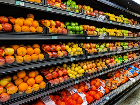 supermarket shelves with fruit and veg