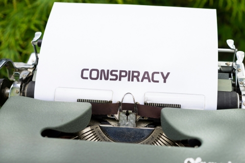 typewrite with the word conspiracy typed onto a piece of paper.