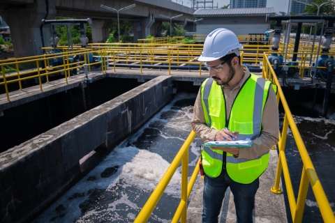 Engineer take water from  wastewater treatment pond to check the quality of the water. After going through the wastewater treatment process.