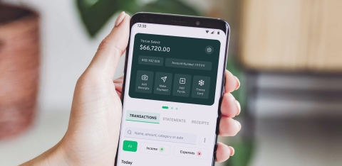 Picture of hand holding phone showing finance app - Photo by Thriday on Unsplash