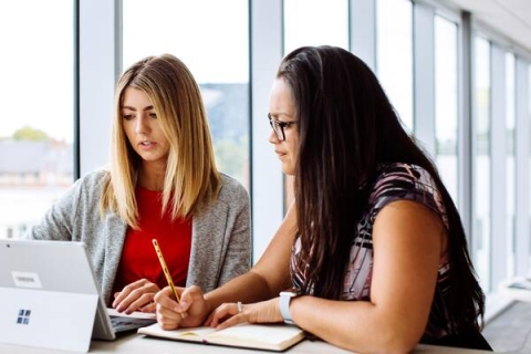 two-women-looking-at-a-screen