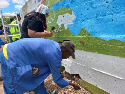 two people painting a mural