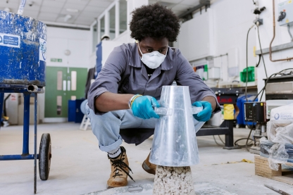 Student carefully revealing moulded clay pile