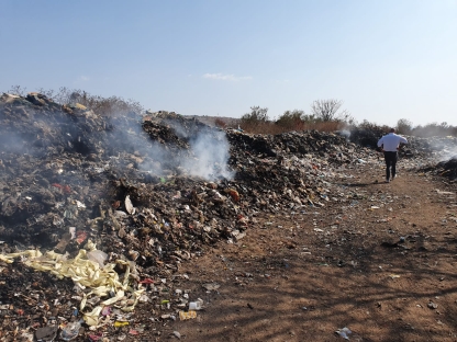 Large pile of rubbish with smoke coming out