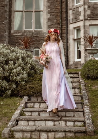 Pink sheer dress in front of historic building