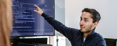 Student showing HTML on a projected computer