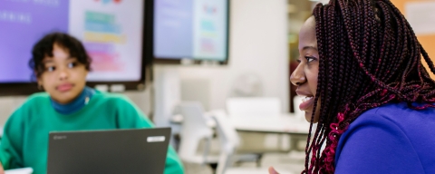 Woman in purple top presenting