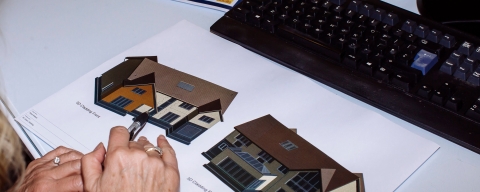 Hands working on construction plans