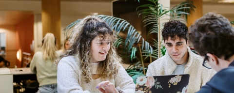 Three students conversing in a study space