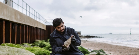 Palaeontology students Hamzah Imran on Southsea beach by the old seawall