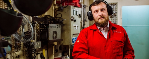 A man in red Wight Link uniform near control boxes