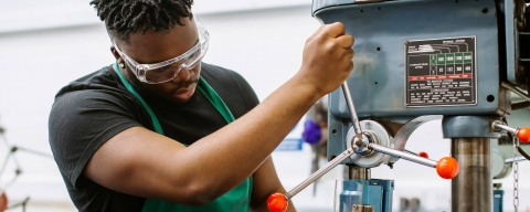 Student using a piece of engineering equipment