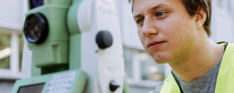 Student conducts measurements using landscape mapping device outside Technology Facilities