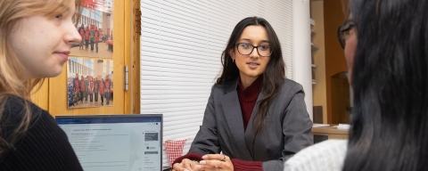 Woman wearing a grey suit consulting in a legal clinic