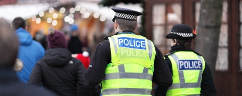 Two police officers in busy street
