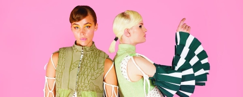 Two people wearing student fashion designs by Tassia Murray