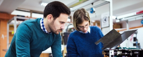 male and female student observing machine