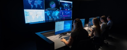 Students sitting in front of surveillance screens