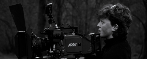A camera person on location with an Arri Alexa camera