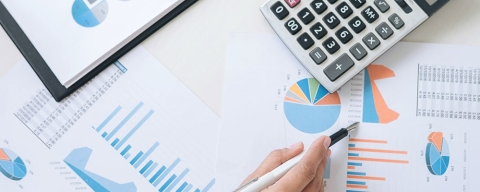 international finance and banking student with charts and calculator