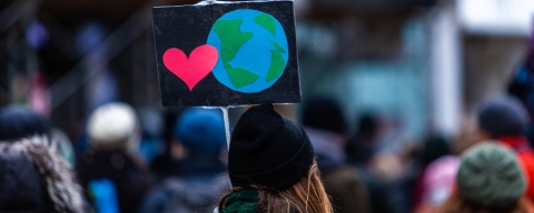 Woman holding sign at environmental march