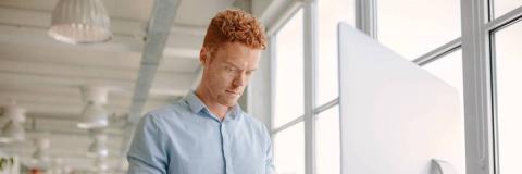 A man working at a desk with a screen