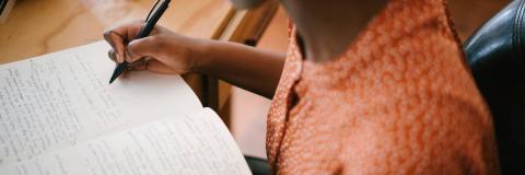 Student writing in a notebook