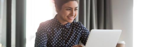 Smiling student on a laptop