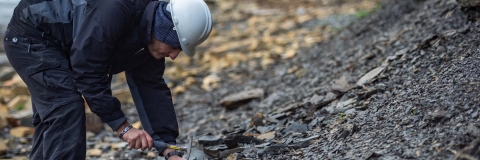 A researcher on a field trip inspecting a sample