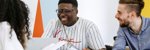 Students studying together in a group smiling and enjoying themselves