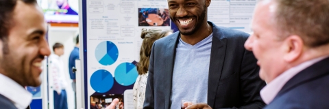 Three men at a business fair