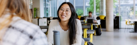 Student hanging out in Eldon cafe with a friend.