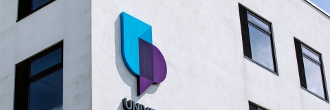 corner of University of Portsmouth building with logo